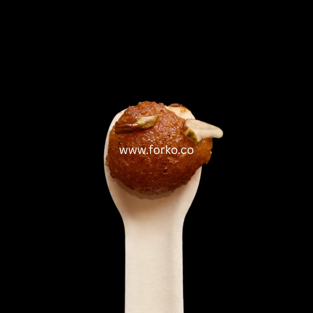 Paper ice cream spoon holding a gulab jamun