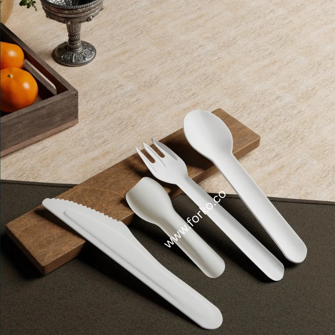 Forko Green biodegradable paper knife, ice cream spoon, fork and spoon laid out for export